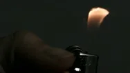Slo Mo Cu Hand Igniting Cigarette Lighter Against Black Background Stock Footage