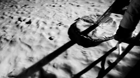 SLO MO, CU, Lockdown, HA, low section of an astronaut climbing down the ladder Stock Footage