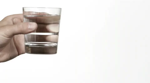 SLO MO CU Studio shot of hand pouring water from glass against white background Stock-Footage 51860618