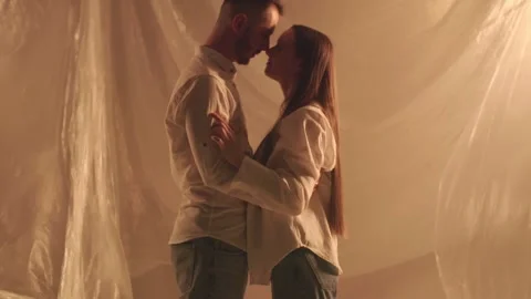 Slo mo of cute couple touching noses each other and dancing. Pair in love kiss Stock Footage 253624814