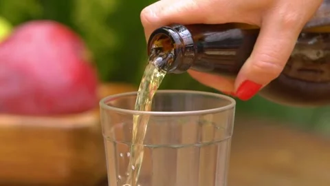 SLO MO DS Light beer being poured into a glass bubbles, foam and vibrant ambe Stock Footage 265768110