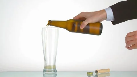 SLO MO DS Light beer being poured into a glass bubbles, foam and vibrant ambe Stock Footage 265768807