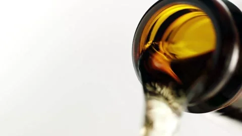 SLO MO DS Light beer being poured into a glass bubbles, foam and vibrant ambe Stock Footage 265836890