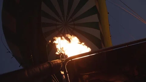Slo mo fuel and fire entering hot air balloon before safari ride in Kenya Stock Footage 339969139