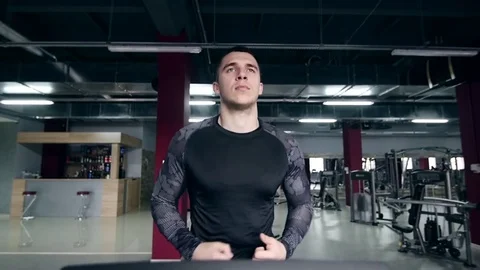 SLO MO LA Medium Shot Pan Man jogging on treadmill Stock Footage 75354939