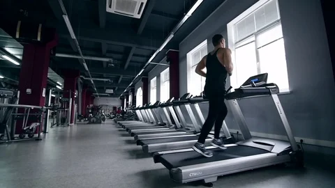 SLO MO LA Medium Shot Pan Man jogging on treadmill 動画素材 75355378