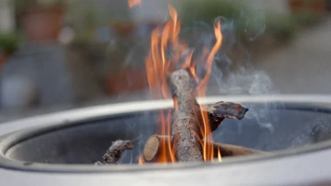 SLO MO LD Logs burning in a fire bowl outside Stock Footage 201686057