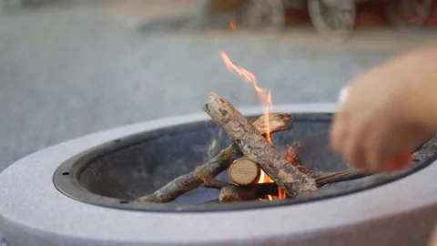 SLO MO Lighting a fire in a fire bowl in the garden Stock Footage 201685792