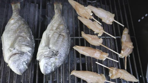 SLO MO Meat and fish grilling on the BBQ. Top view Stock Footage 244953440