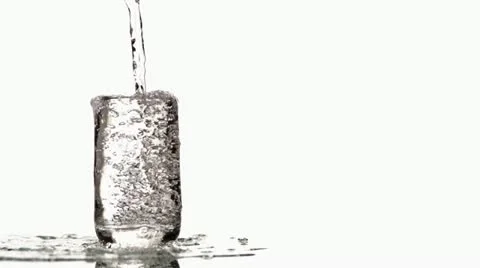 SLO MO MS Studio shot of water being poured into glass against white background Stock Footage 11292665