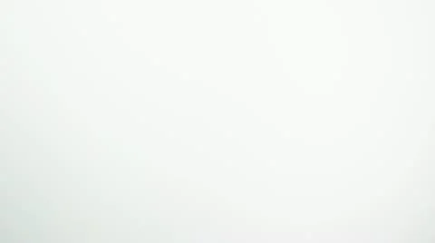 SLO MO MS Studio shot of two wedding rings falling against white background Stock Footage 11292804