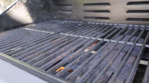 SLO MO Outside grill heating up and light smoke coming out Stock Footage 244993630