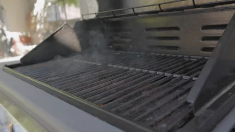 SLO MO Outside grill is turned on and smoke is coming out when it starts to heat Stock Footage 244989640