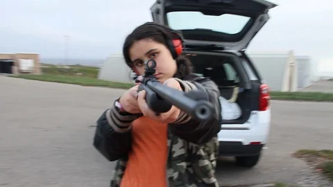 Slo-mo pan around kid aiming gun (and into camera) Stock Footage 113912427
