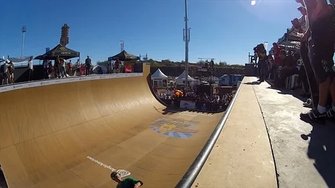 Slo mo of skater doing a 360 varial kick-flip on a vert half-pipe in Video stock 98308885