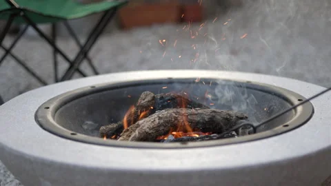 SLO MO Starting a fire in a fire bowl Stock Footage 201682040