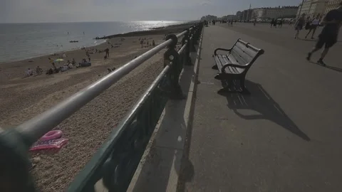 Slo mo tracking shot along seaside promenade Stock Footage 131760703