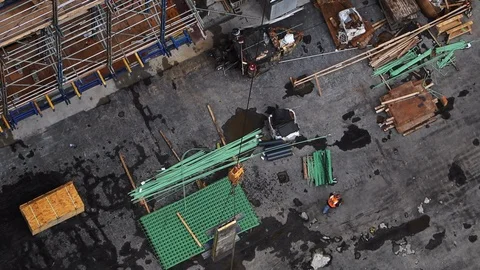 Slo-mo tracking shot of crane hook lifting wall section on high rise Stock Footage 128461945