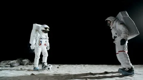 SLO MO, WS, Lockdown of two astronauts on the moon playing soccer Stock Footage