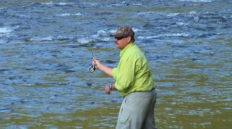 Slo-Mo Zoom Out on Man in Green Casting Line Video stock 24704929