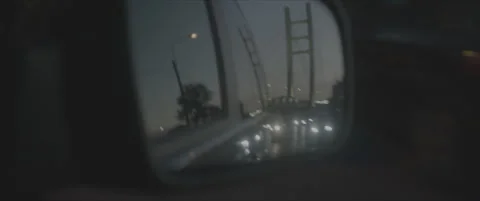 SLog shot of a bridge at night reflected in a car mirror Stock Footage 302354762