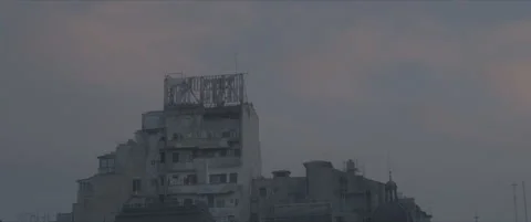 SLog shot of a decaying rooftop against pastel clouds Stock Footage 302363575
