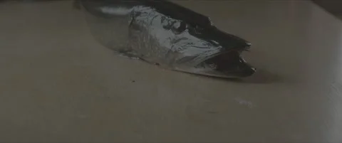 SLog shot of a freshly caught fish lying on a wooden table Stock Footage 302344646