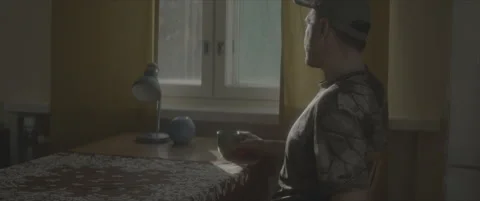 SLog shot of a man leaning over a desk with soft daylight Stock Footage 302347685