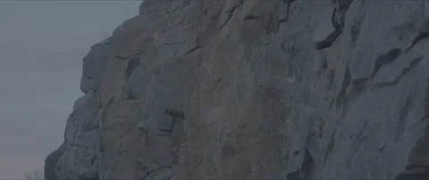 SLog shot of a rugged rock face at dusk Stock Footage 302354034