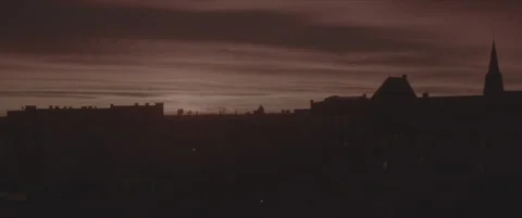 SLog shot of the sun setting behind silhouetted rooftops Stock Footage 302355266