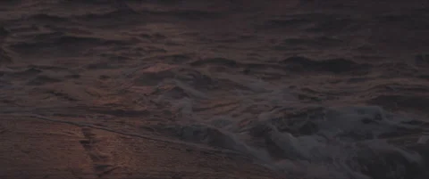 SLog shot of waves reflecting sunset hues Stock Footage 302350643