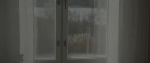 SLog shot of a window with a blurred Scandinavian landscape outside Stock Footage 302344122