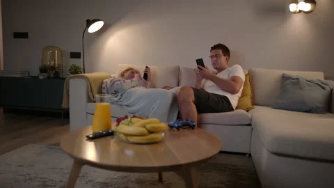 Slomo: Competitive Couple Spending Time Together Scrolling Social Media On Their Stock Footage 135736227