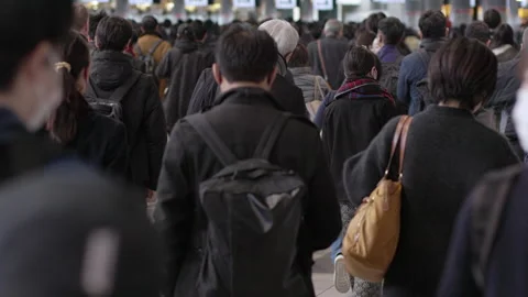 SLOMO Crowds of rush hour commuters in Tokyo from behind (editorial) Stock Footage 295449311