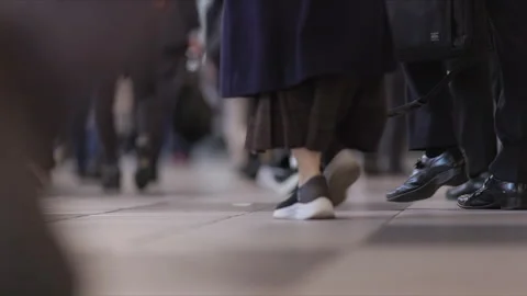 SLOMO Low view of legs walking through Shinagawa Station (editorial) Stock Footage 295745533