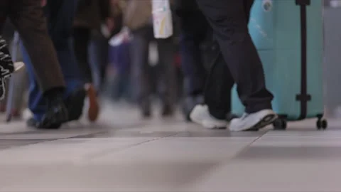SLOMO Low view of legs walking through Shinagawa Station Stock Footage 295745628
