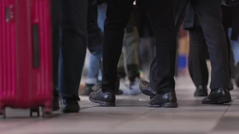 SLOMO Low view of legs walking through Shinagawa Station (editorial) Video stock 295745852