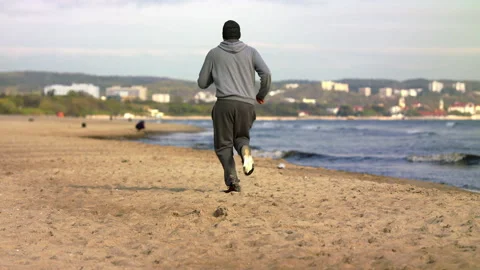 SloMo: Man with Beard Running by the Beach at Dusk - Wide Shot Stock Footage 130730721