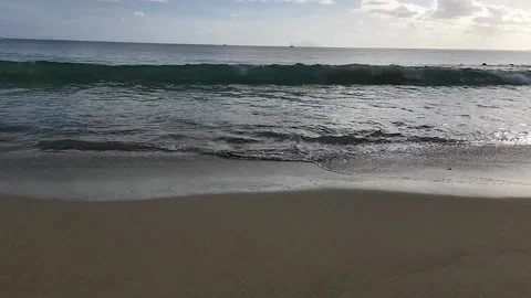 SloMo-Waves break on pristine sandy beach Stock Footage 229911056
