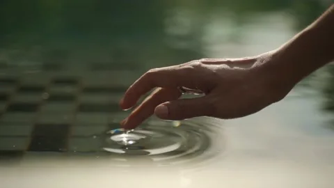 Slomotion Hand Touching Water Video stock 232467982