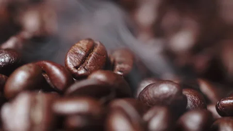 Slomotion smoke comes from coffee beans. Pile of coffee beans smoke. marco shot Stock Footage 196676759