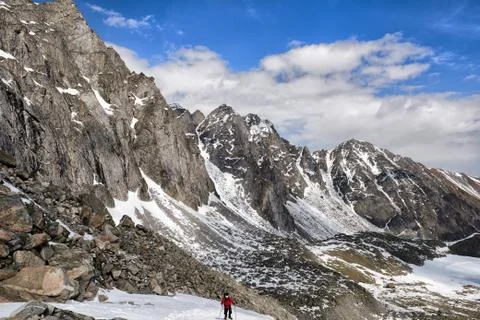Slope of mountain range and one climber on rise Stock Photos