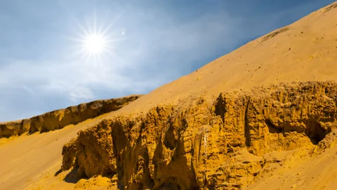 Slope of the sand dune in a desert under a sparkle sun time lapse scene Stock Footage 288063817