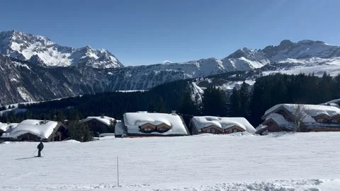 Slopes of Courchevel ski resort with skiing people and chalets Stock Footage 334429302