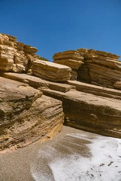 Sloping layered limestone rocks in the Mediterranean landscape on Triopetra.. Stock Photos