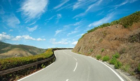 Sloping road with dashed line. Stock Photos