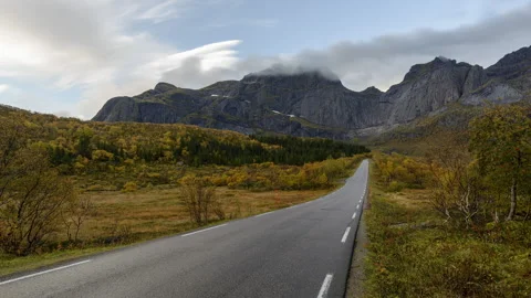Sloping road with mountains in background Stock Footage 250437731