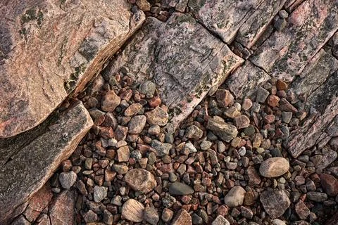 Sloping rock texture and pebbles below Stock Photos