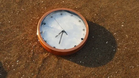 Slopped clock floating on waves to seashore Stock Footage 75805041