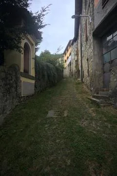 Sloppy cobbled path between stone walls Stock Photos
